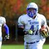 Newtown's Ben Mason carries the ball to the endzone to score after intercepting a Notre Dame of Fairfield pass during football action in Fairfield, Conn. on Saturday Nov. 5, 2016.