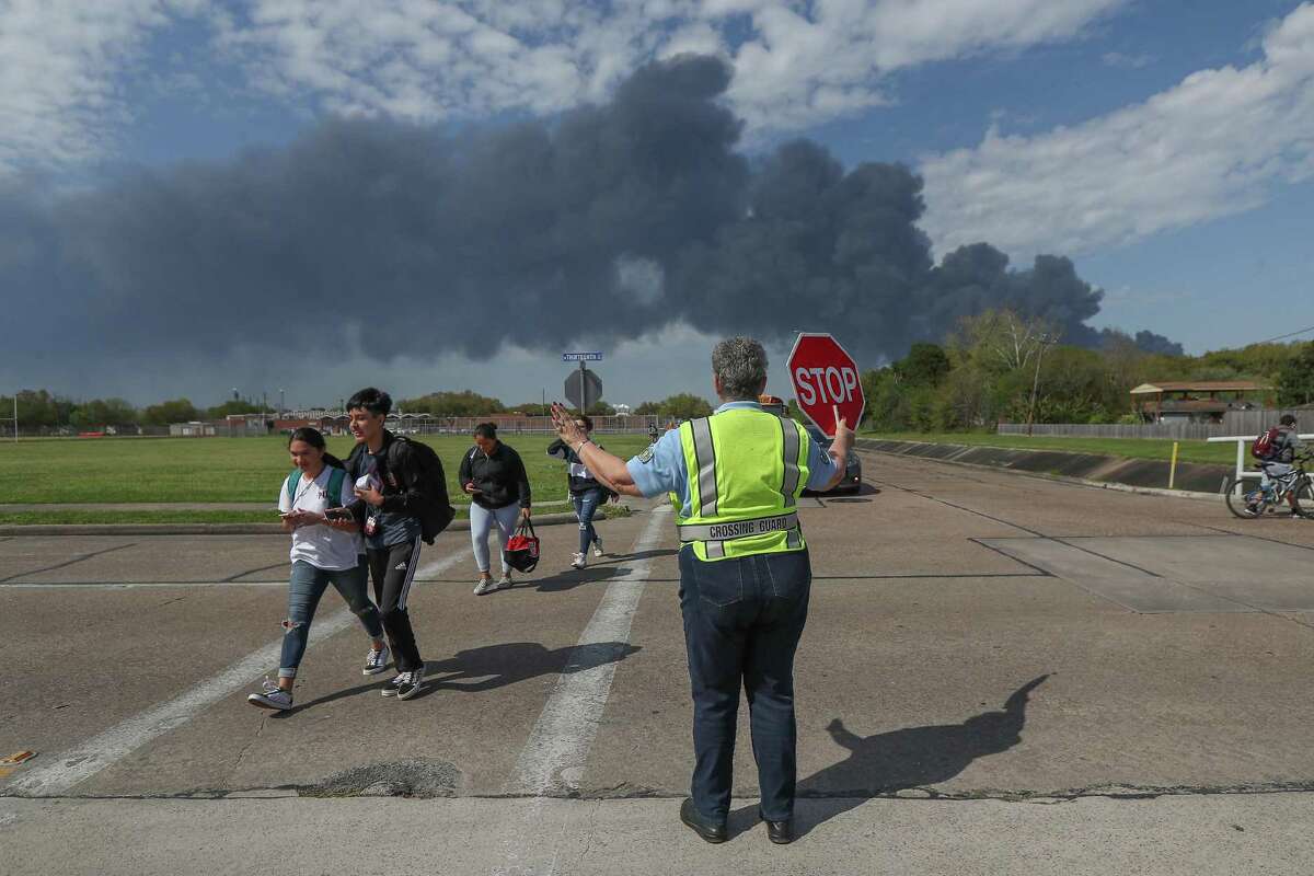 Deer Park PD Crossing Guard Adell Boren makes sure Deer Park Jr. High School students are safe as they cross East 13th and Meadowlark Streets in spite of a chemical fire burning nearby Tuesday, March 19, 2019, in Deer Park. Harris County Commissioners Courto on Tuesday OK'd $900,000 settlement with the company.