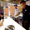 Austin-based artist and muralist Jay Muzacz (center) looks on as KO Korean Barbecue manager Abe Song points out menu items to owner Min Dai. KO Korean Barbecue is nearly finished and will have a soft opening this week. Photo made Monday, April 19, 2021 Kim Brent/The Enterprise