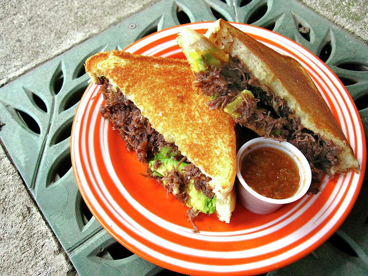 Two San Antonio joints offer Mexican grilled cheese sandwiches to try now, according to Texas Monthly, including the sandwich shown in the photo from Birrio Barista.