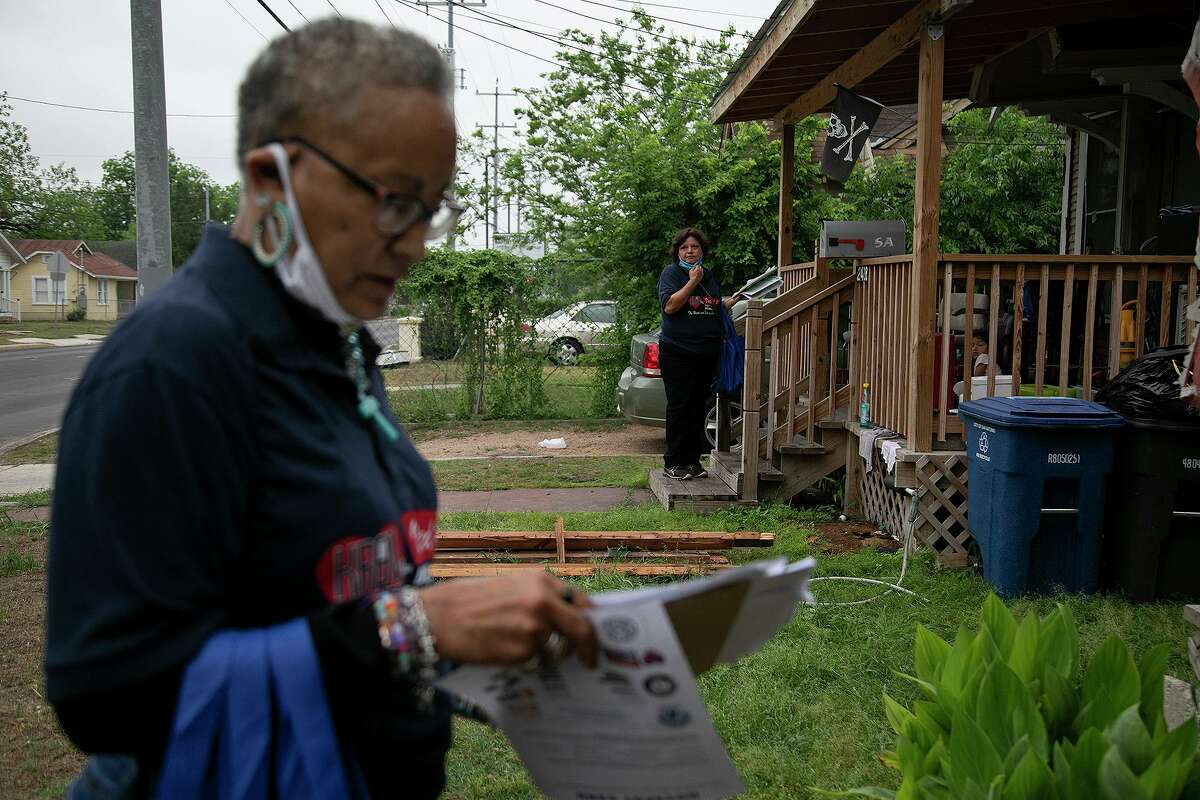 WestCare Foundation staff members Rosie Baca and Rita Bethany, left, block walk along East Houston Street leaving information about what WestCare offers for local residents in San Antonio on April 27, 2021.