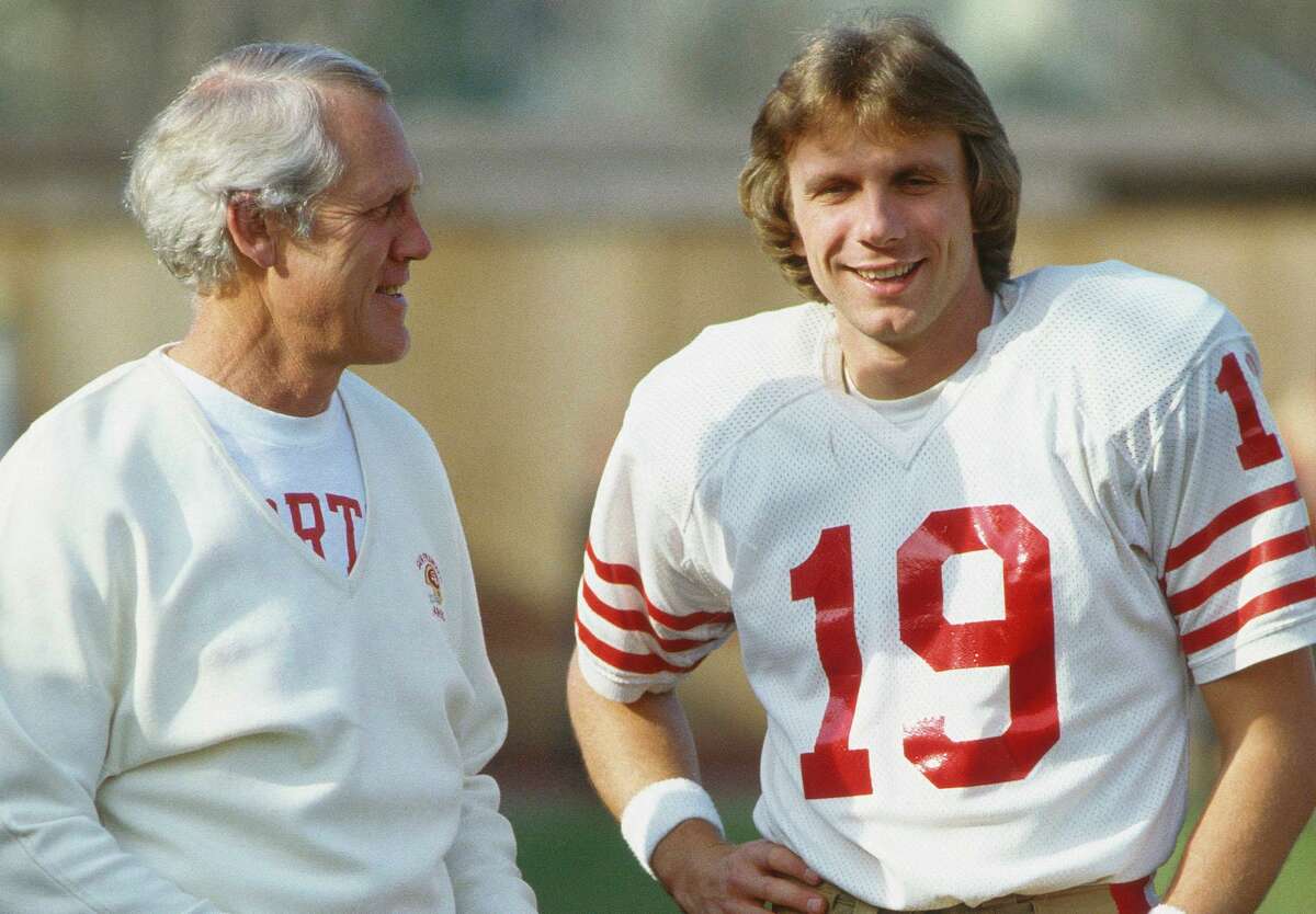 San Francisco 49ers' quarterback Joe Montana #19 talks to his coach, Bill Waish during the 1981 season. (Photo by Focus on Sport/Getty Images)
