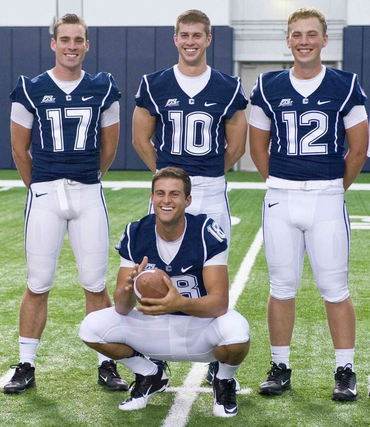 UConn quarterbacks Blaise Driscoll (17), Chandler Whitmer (10), Casey Cochran (12) and Johnny McEntee, front, pose during the an NCAA football media day in Storrs, Conn., Friday, Aug. 10, 2012.