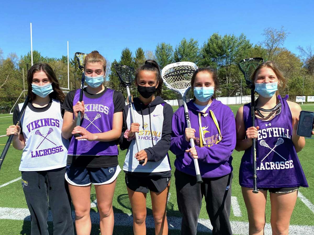 The Westhill girls lacrosse team has three sets of twins. Left to right: Anna and Audra Hansen, Olivia and Ava Feliciano and Victoria and Gabriella Wloszek (Gabriella is on FaceTime because she is home quarantining) on Wednesday.
