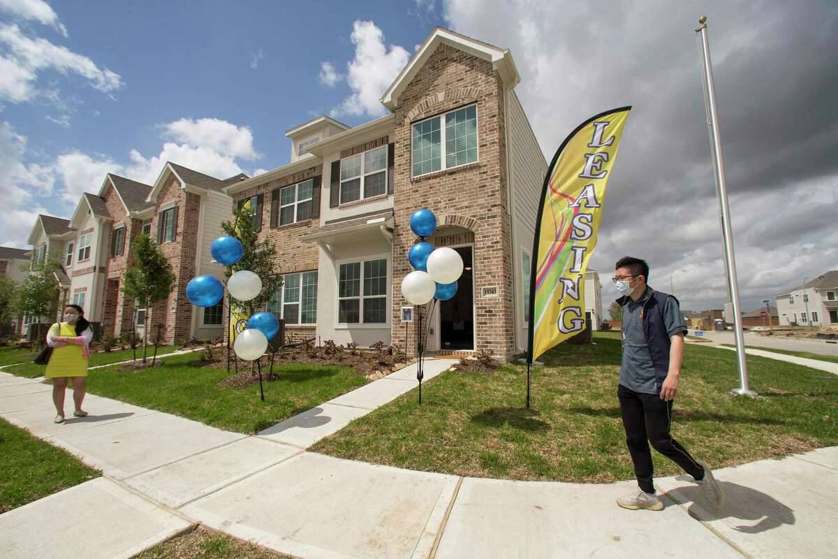 Tung Qiao, CEO of Wan Bridge Group, walks past a row of single family townhomes that are completed and ready to lease in the Clearwater at Balmoral subdivision Tuesday, April 6, 2021 in Atascocita. Single-family rentals are drawing increased interest from investors making the bet that people want to live in single-family houses but either will not be able to afford to buy or want to maintain their amenity-rich turnkey lifestyle.