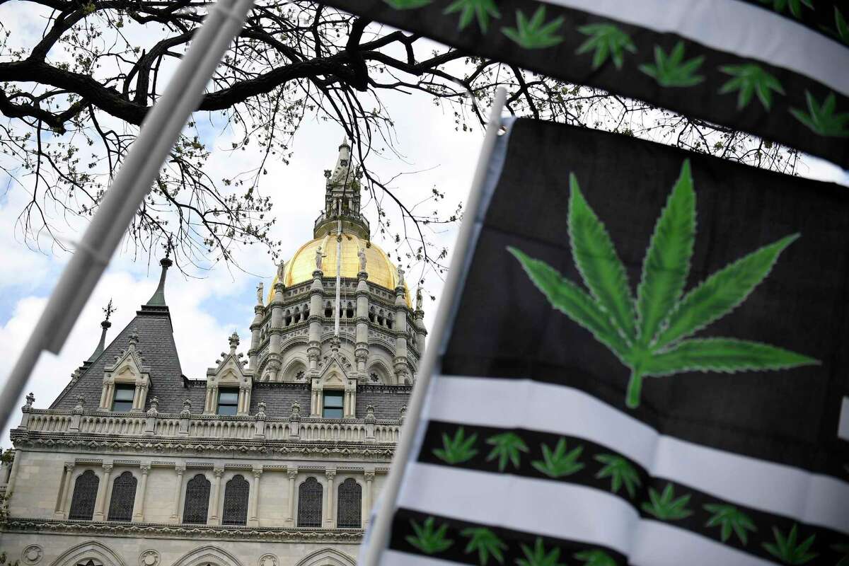 Flags with a marijuana leaf wave outside the Connecticut State Capitol building April 20, 2021 in Hartford.