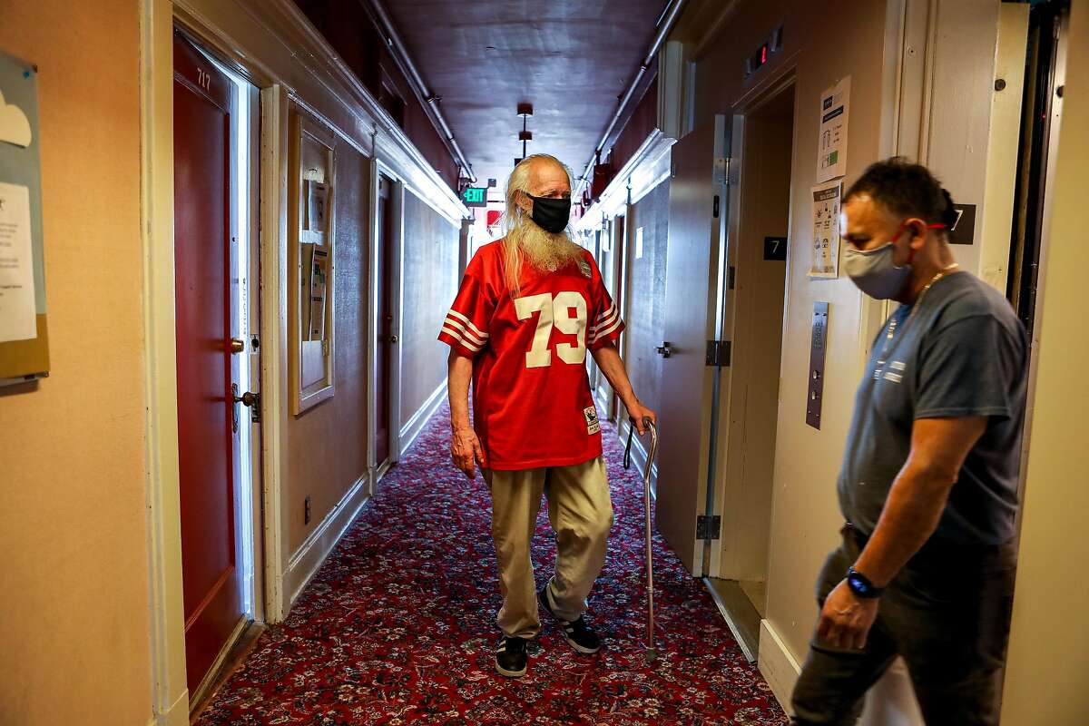 John Susoeff, 77, catches an elevator in March at the Granada Hotel in San Francisco, where he has lived for 16 years. Gov. Gavin Newsom proposes to devote another $9 billion to convert motels and hotels into supportive housing for homeless people.