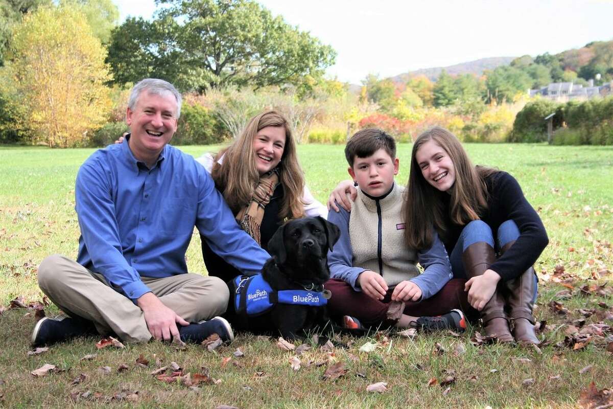 The Collins family, of Ridgefield, were matched with BluePath service dog Chelsea in 2019. The pup is specially trained to provide safety, companionship and opportunities for independence for children with autism.
