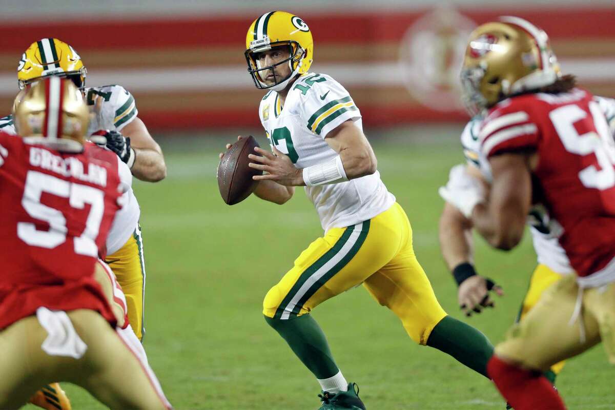 Green Bay Packers' Aaron Rodgers rolls out in 2nd quarter against San Francisco 49ers during NFL game at Levi's Stadium in Santa Clara, Calif., on Thursday, November 5, 2020.