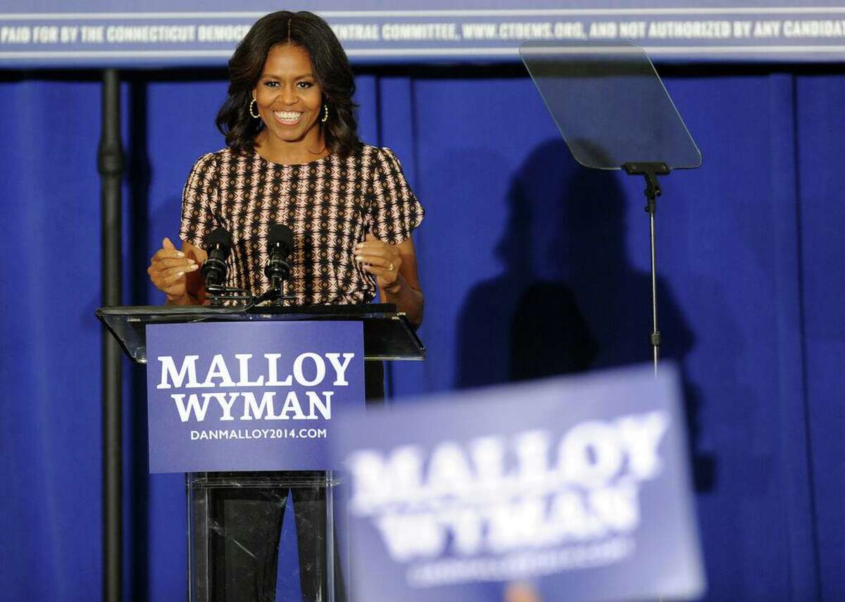 First lady Michelle Obama urges residents to get out and vote Thursday, Oct. 30, 2014, during a rally to support Gov. Dannel Malloy at Wilbur Cross High School in New Haven, Conn.