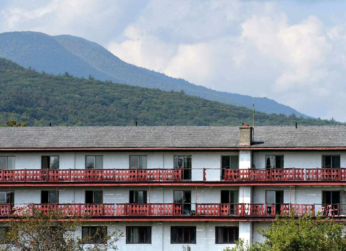 A Catskill mountain backdrop is seen behind the old Friar Tuck resort on Friday, Sept. 25, 2020, in Catskill, N.Y. Chinese investors have big plans for the long-dormant Catskill Friar resort including water park, skating rink and retail village. Resort is over 200 acres in Catskill but needs major renovation. (Will Waldron/Times Union)