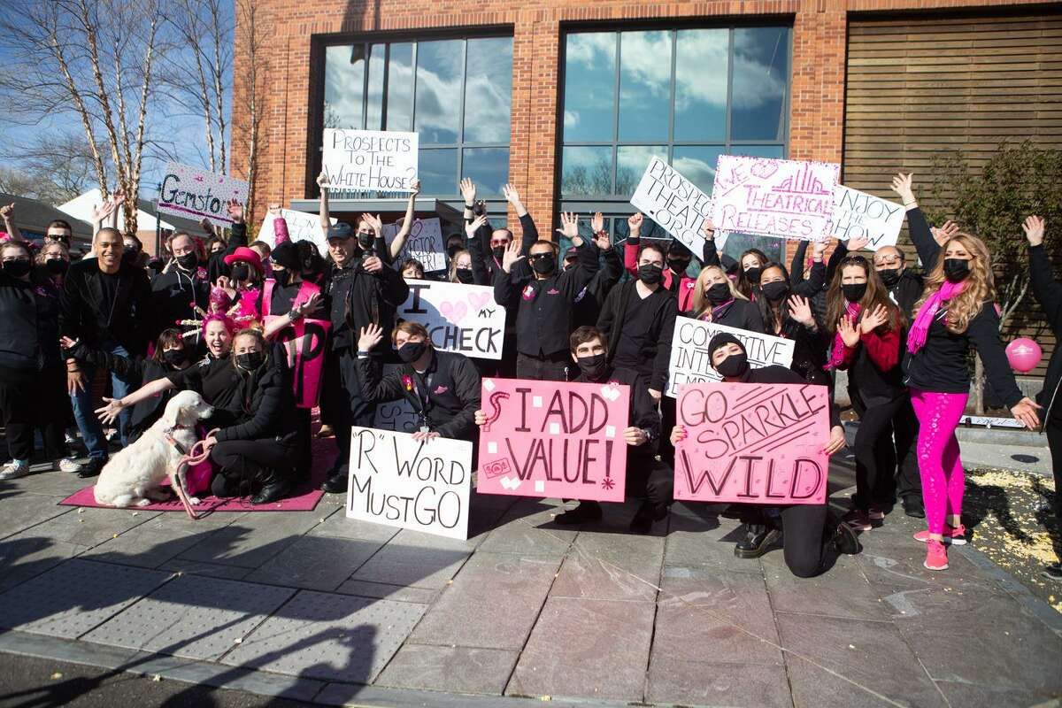 Prospects pose outside Ridgefield's Prospector Theater alongside "Good Morning America" anchor TJ Holmes, holding hand-drawn signs displaying messages of hope, on Monday, April 26.
