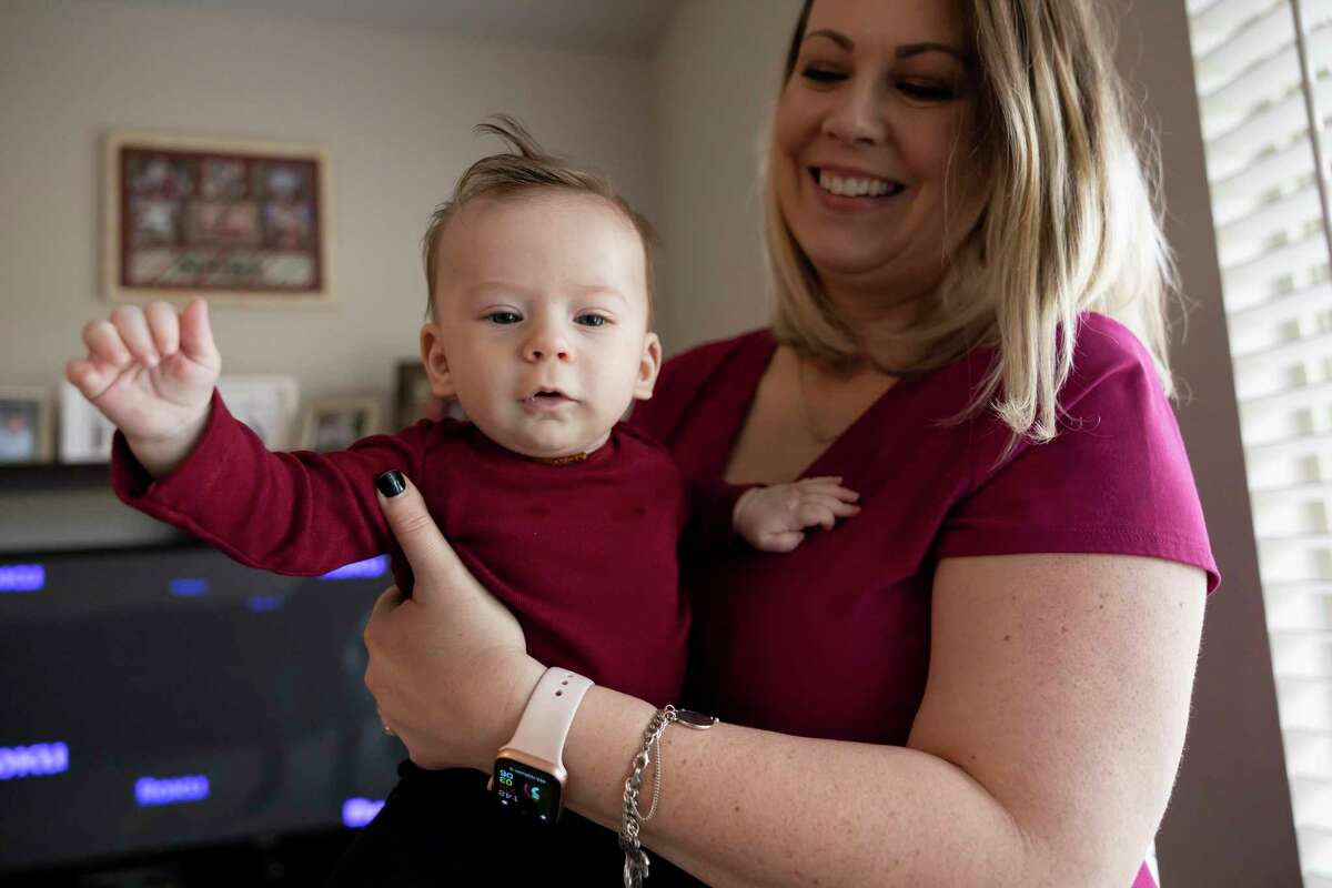 Victoria Rasberry smiles as she plays with her son, Ollie, in their home, Wednesday, Feb. 10, 2021, in Conroe. Ollie lives with a rare genetic disorder called Metachromatic Leukodystrophy which impacts the central nervous and peripheral system. The mom and son are in Italy for a pioneering medical treatment that began in May.