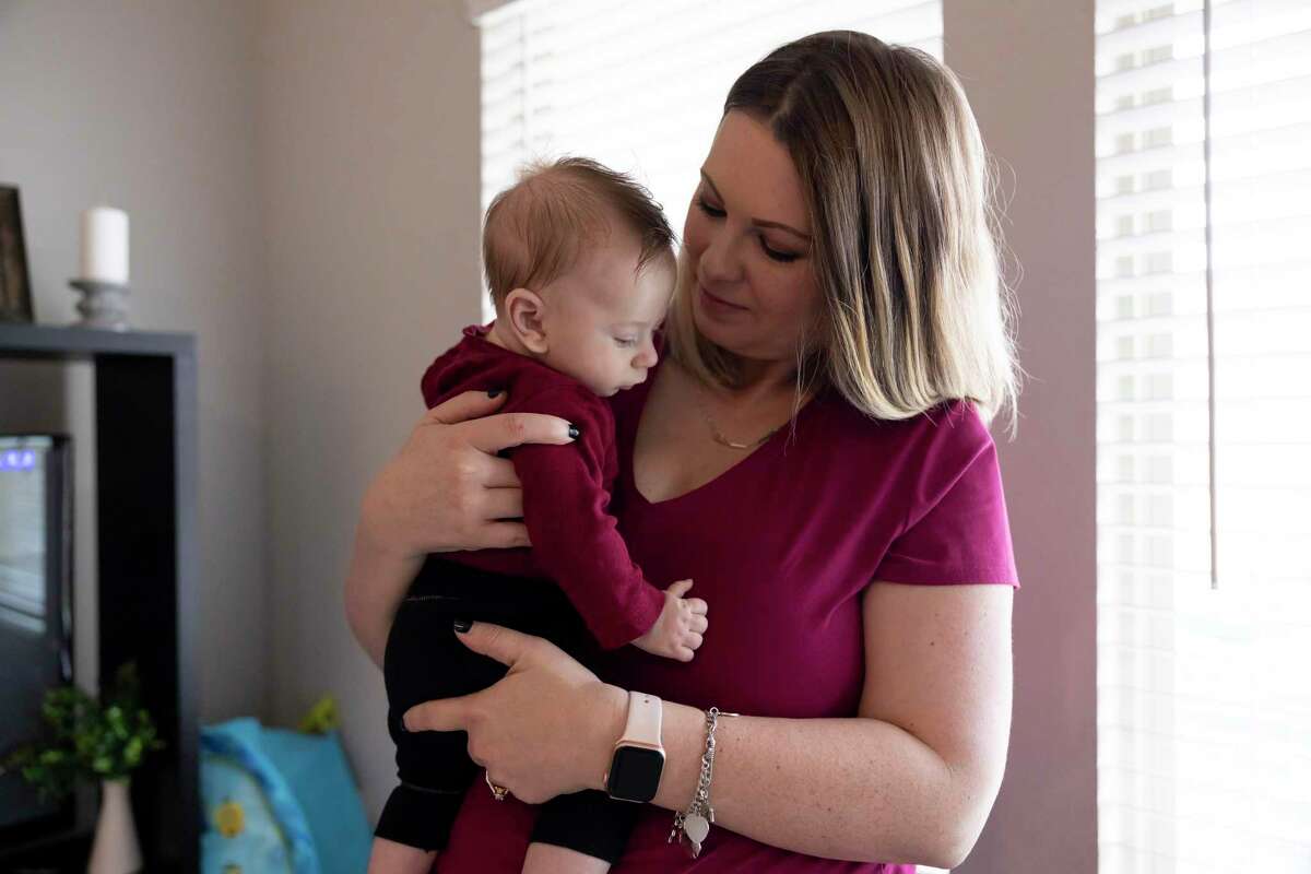 Victoria Rasberry embraces her son, Ollie, in their home, Wednesday, Feb. 10, 2021, in Conroe.Ollie and his sister, Addi, both live with a rare genetic disorder called Metachromatic Leukodystrophy which impacts the central nervous and peripheral system.