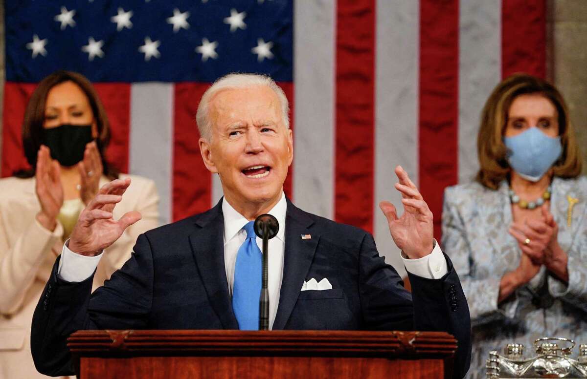 TOPSHOT - US President Joe Biden addresses a joint session of Congress as US Vice President Kamala Harris and US Speaker of the House Nancy Pelosi applaud at the US Capitol in Washington, DC, on April 28, 2021. (Photo by Melina Mara / POOL / AFP) (Photo by MELINA MARA/POOL/AFP via Getty Images)