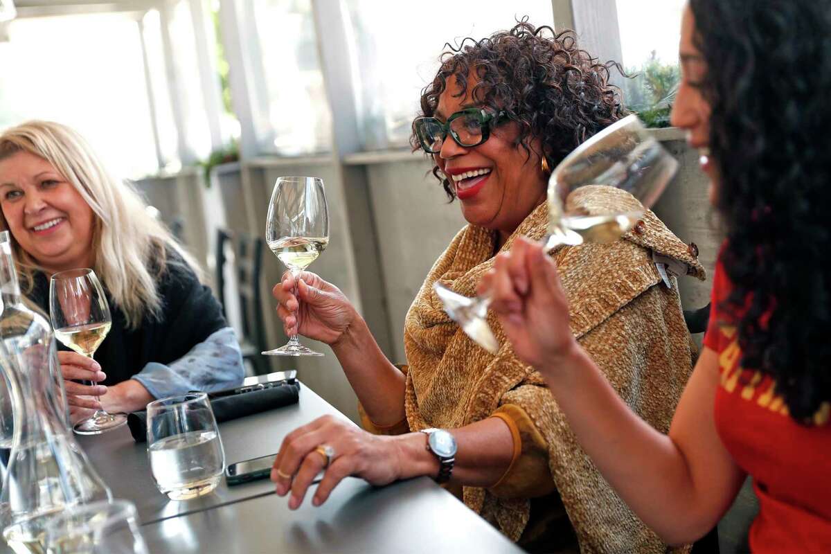 Katia Flitnar (left), Deborah Cali and Caycee Cali dine at Cultivar on Chestnut Street in San Francisco. The city is on track to gain entry to the yellow tier of California's pandemic restrictions.