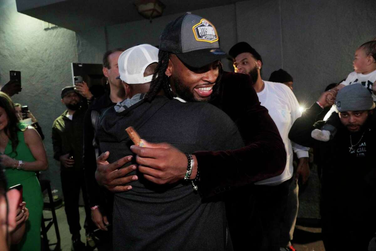 Najee Harris celebrates with family and friends after his selection in the 2021 NFL Draft at Rob Ben’s restaurant in Emeryville Calif., on Thursday, April 29, 2021. Harris was picked 24th overall by the Pittsburgh Steelers.