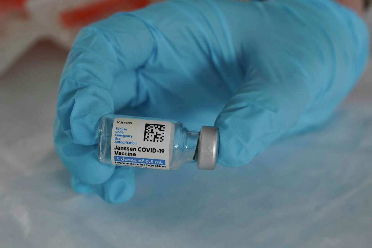 In this March 3 file photo, U.S. Army medic Kristen Rogers, of Waxhaw, N.C., holds a vial of the Johnson & Johnson COVID-19 vaccine in North Miami, Fla. With the U.S. pause of the vaccine, authorities are weighing whether to resume the shots the way European regulators decided to -- with warnings of a