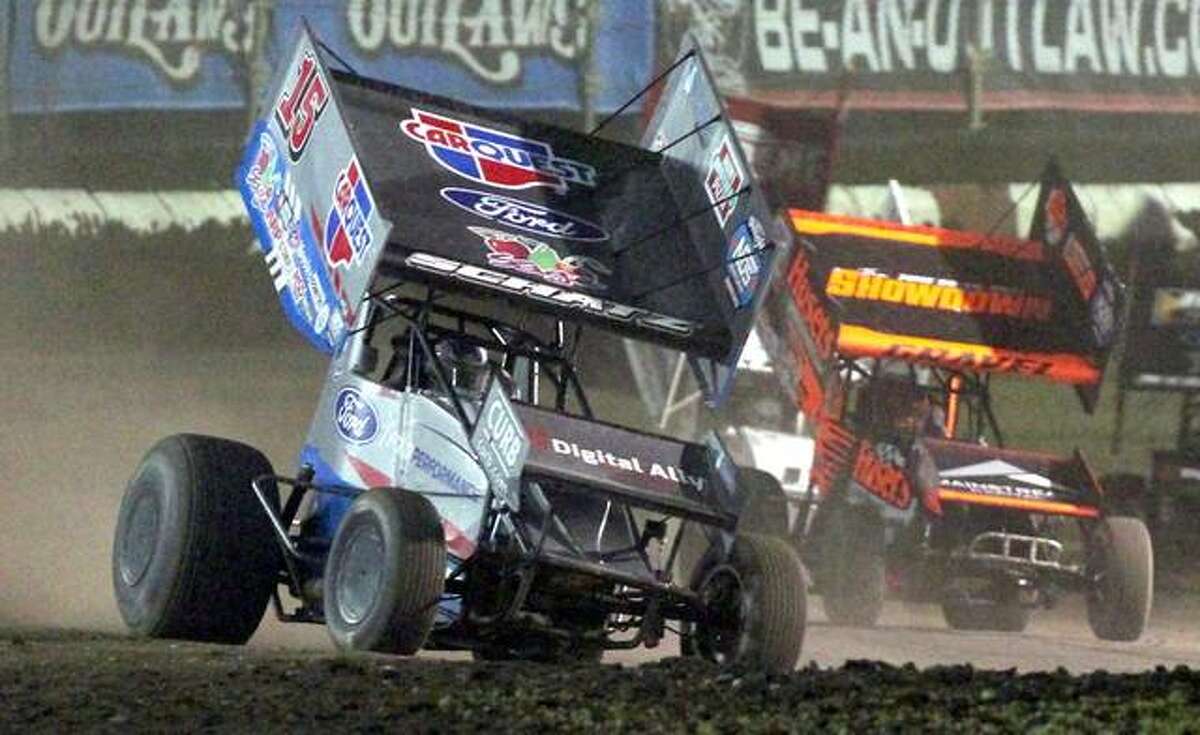 Cars race around the track Thursday night at the World of Outlaws NOS Energy Drink Sprint Car Series race at Jacksonville Speedway.
