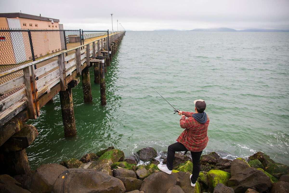 Leo Barkos fishes for halibut in between the Berkeley Pier and the restaurant Skates on the Bay.Barkos grew up fishing here with his older brother but still tries his hand at shore fishing since the pier closed.