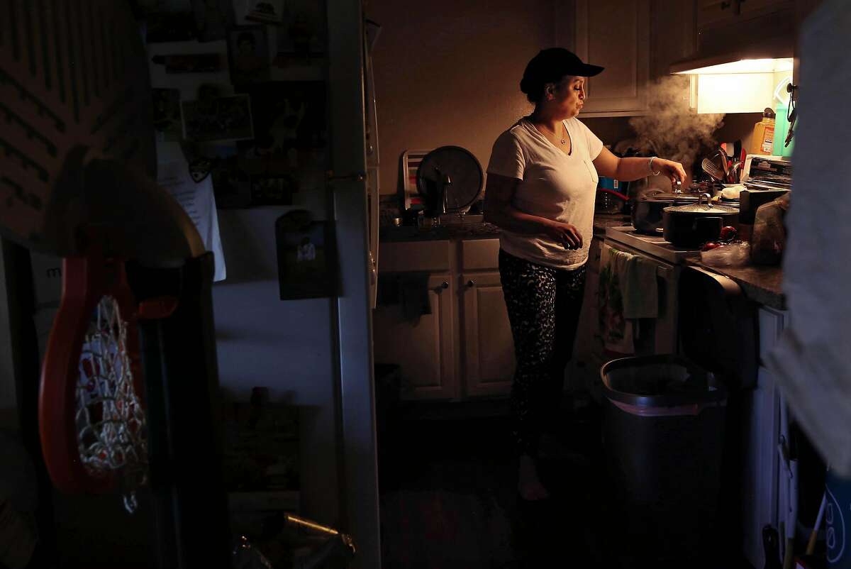 Abin Rahbar prepares dinner in her Palo Alto home. The dental hygienist stopped working during the pandemic for fear of bringing the virus home to her kids and is now struggling to afford the rent in Palo Alto.