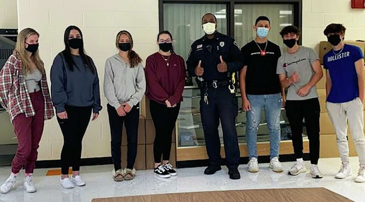 Shelton Police Officer John Staples, the department's school resource officer and crime prevention officer, with students at Shelton High. Staples is offering his Small City Big Dreams program to students at Perry Hill, Shelton Intermediate and Shelton High schools.