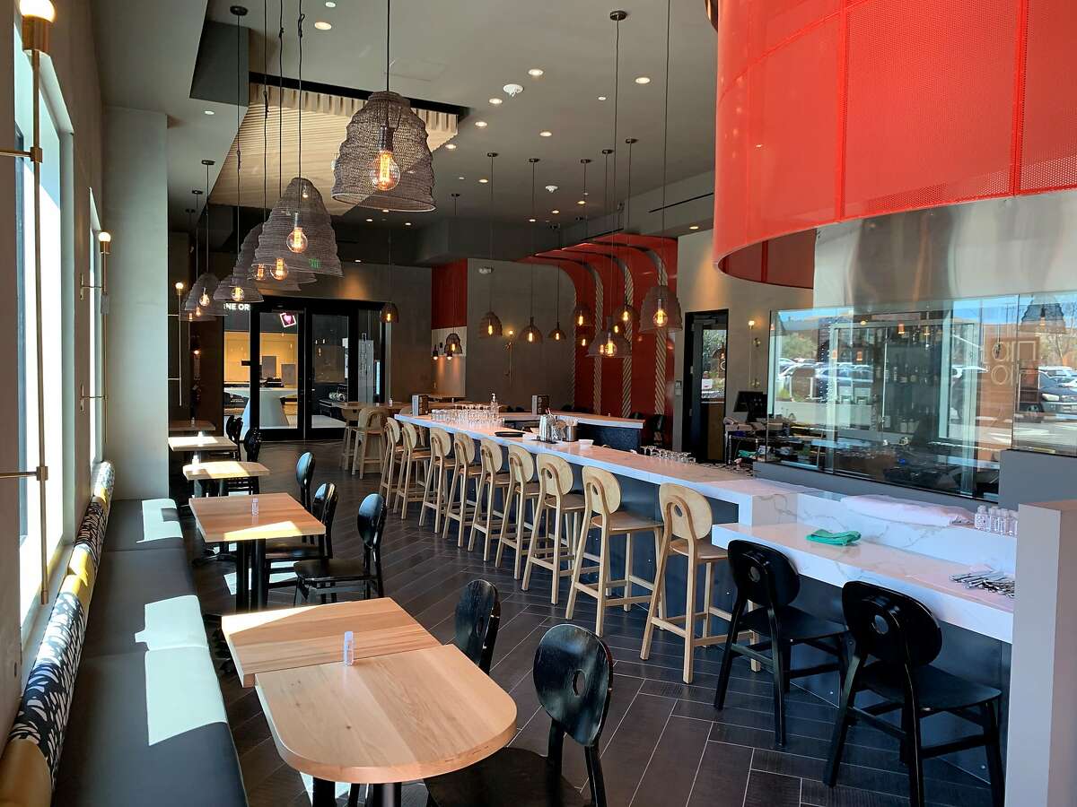 The dining room and open kitchen at AnQi Shaken and Stirred in Santa Clara, a new restaurant from the family behind San Francisco's Thanh Long.
