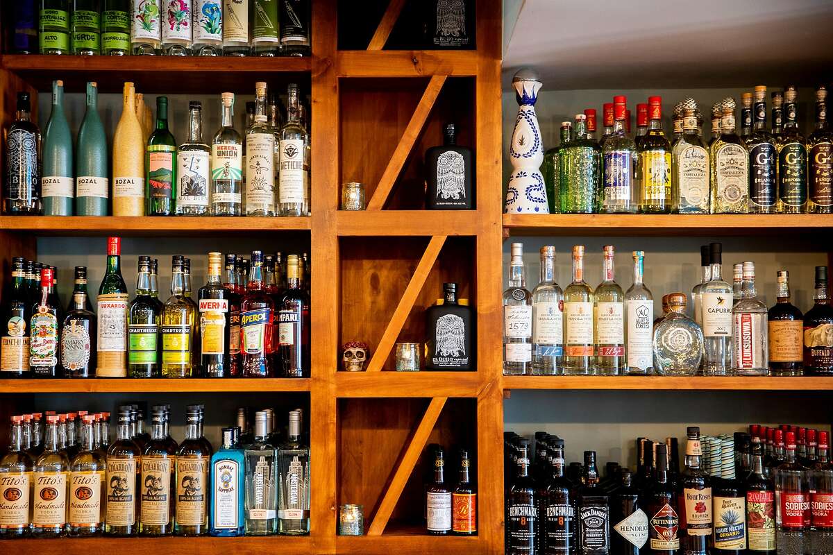 Various bottles of mezcal and tequila sit behind the full bar at Otra in the Haight-Ashbury neighborhood of San Francisco, Calif. Friday, April 30, 2021. The team behind eclectic Mission District favorite Son's Addition is gearing up for a new, funky restaurant in the Lower Haight called Otra. Chef and co-owner Nick Cobarruvias is taking inspiration from the simple, homey Mexican food he ate as a kid but presenting it in a contemporary way, with freshly made masa and heirloom beans as the driving force.