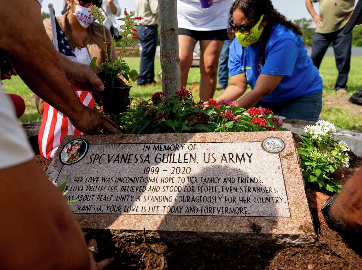 Members of Gathering of Eagles, a local veterans group, and community members work to plant flowers around a planted tree to honor Houston native Pfc. Vanessa Guillen, at Veterans Memorial Park on Saturday, Sept. 19, 2020, in Houston.