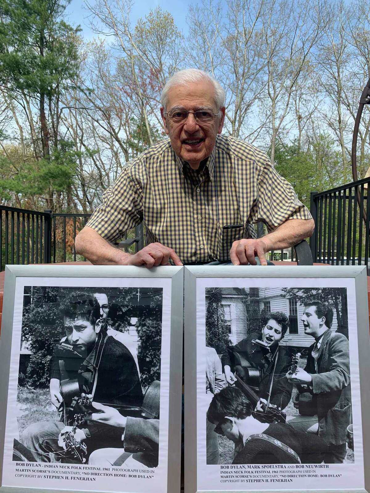 Stephen H. Fenerjian, 87, shows off two of the photographs he took of Bob Dylan at the 1961 Indian Neck Folk Festival in Branford when Fenerjian was 27. The photo of Fenerjian was taken by his son, Stephen M. Fenerjian, also known as Stephen Fenerjian Jr.