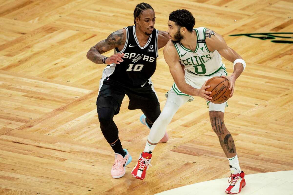 BOSTON, MASSACHUSETTS - APRIL 30: Jayson Tatum #0 of the Boston Celtics dribbles the ball while guarded by DeMar DeRozan #10 of the San Antonio Spurs at TD Garden on April 30, 2021 in Boston, Massachusetts. NOTE TO USER: User expressly acknowledges and agrees that, by downloading and or using this photograph, User is consenting to the terms and conditions of the Getty Images License Agreement. (Photo by Maddie Malhotra/Getty Images)