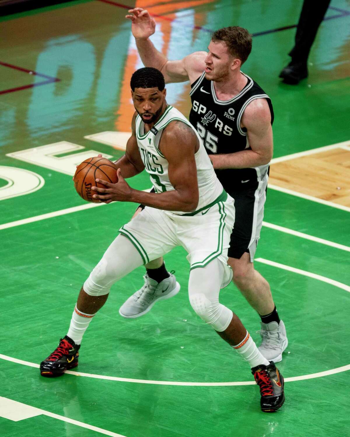 BOSTON, MASSACHUSETTS - APRIL 30: Tristan Thompson #13 of the Boston Celtics and Jakob Poeltl #25 of the San Antonio Spurs battle for a rebound at TD Garden on April 30, 2021 in Boston, Massachusetts. NOTE TO USER: User expressly acknowledges and agrees that, by downloading and or using this photograph, User is consenting to the terms and conditions of the Getty Images License Agreement. (Photo by Maddie Malhotra/Getty Images)