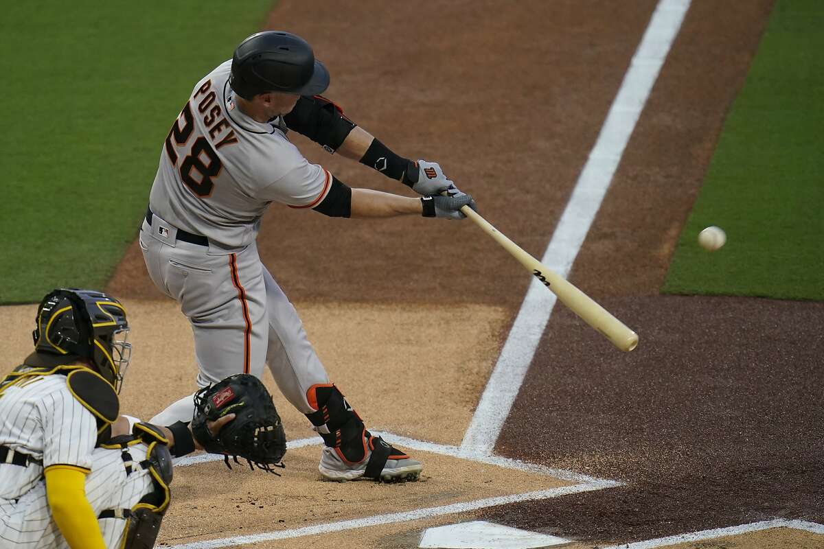 San Francisco Giants' Buster Posey hits a home run during the first inning of a baseball game against the San Diego Padres, Friday, April 30, 2021, in San Diego. (AP Photo/Gregory Bull)