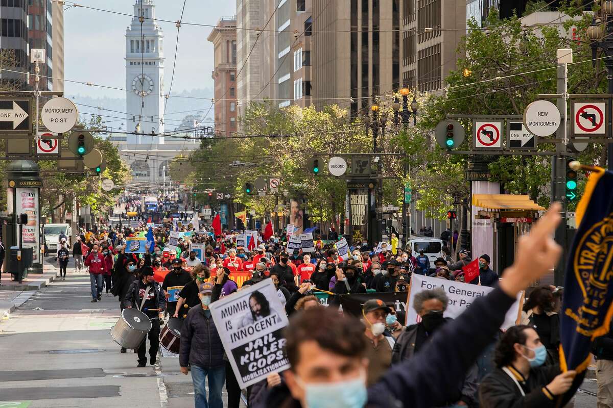 Hundreds of labor union workers and their supporters march up Market Street in S.F. to mark May Day.