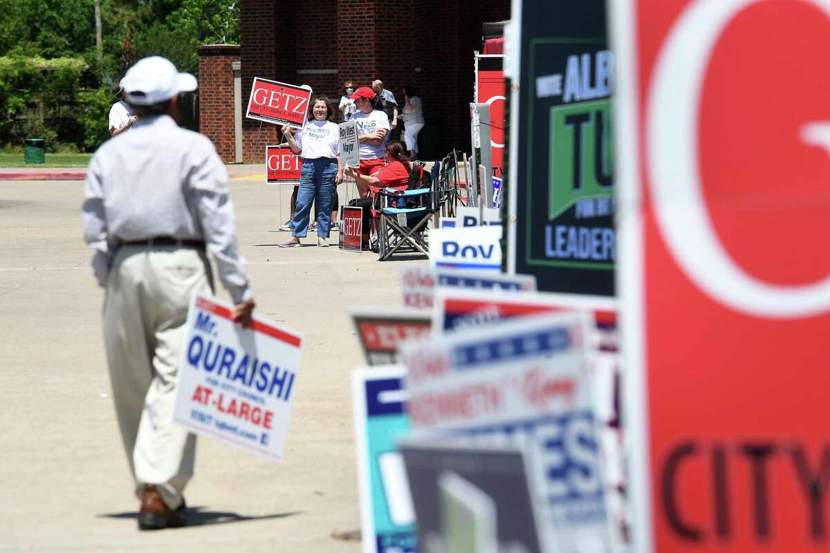 Candidates and campaign workers work the entry to the Rogers Park polling site on the second day of early voting. Photo made Tuesday, April 20, 2021 Kim Brent/The Enterprise