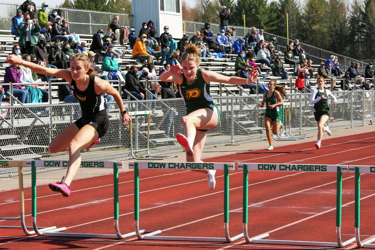 Dow's Lauren Burgard, center, competes in a hurdles event during the Graves/Swayze Relays Saturday, May 1, 2021 at H. H. Dow High School. (Doug Julian/for the Daily News)