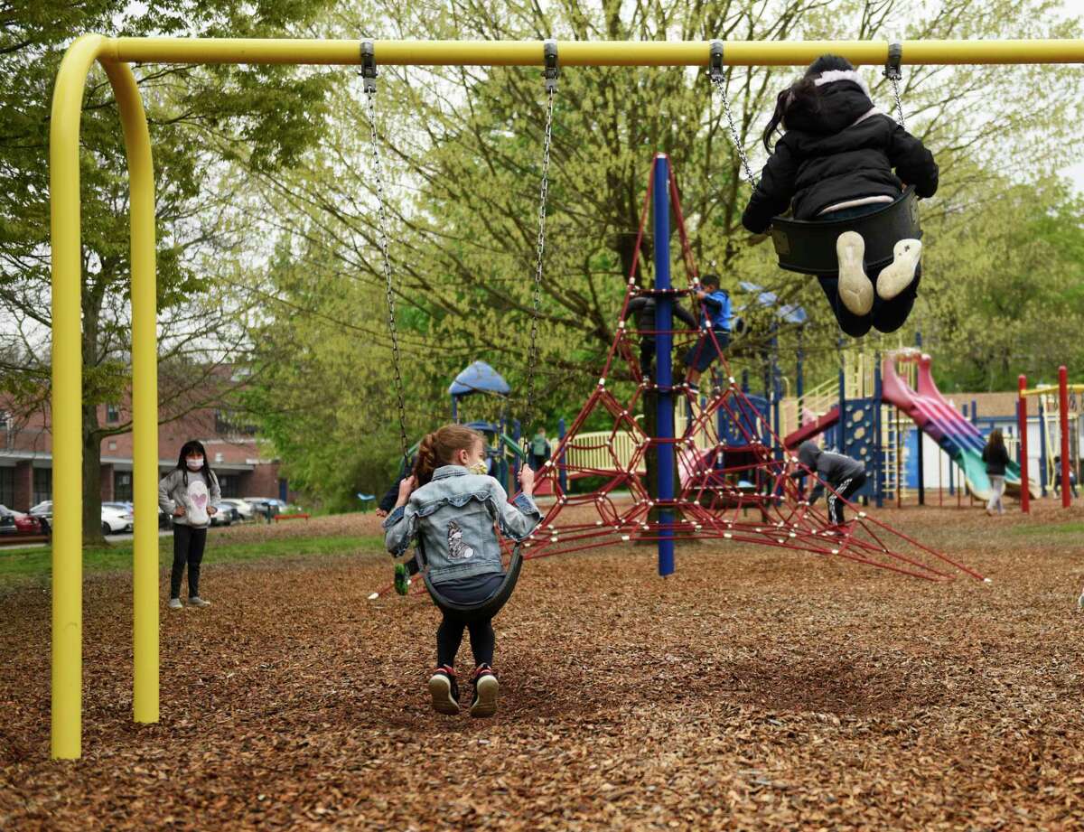 Children play on the playground during recess at Springdale Elementary School in Stamford, Conn. Thursday, April 29, 2021. Stamford schools re-opened playgrounds this week for the first time since the beginning of the pandemic.
