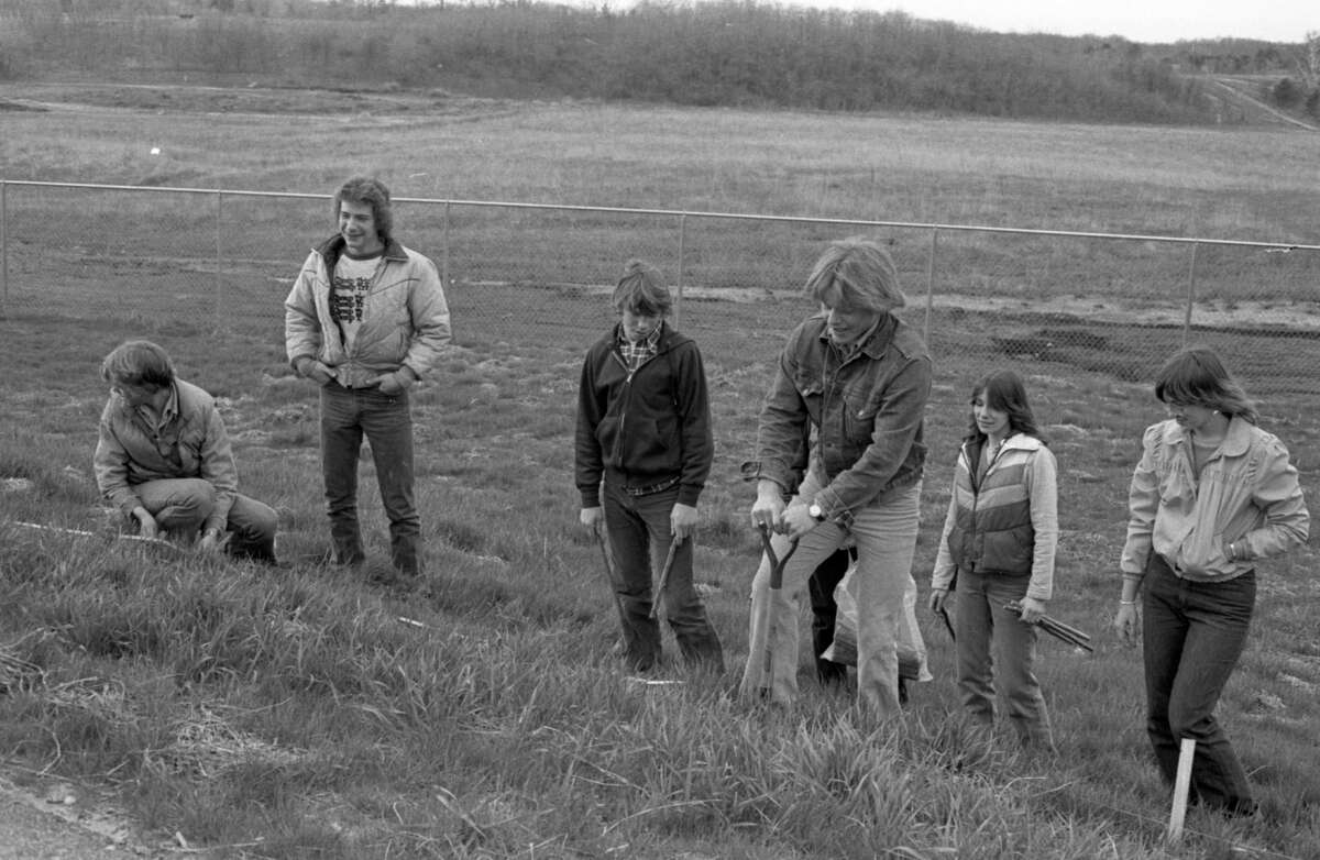 Ninth graders from Manistee High School's general biology class planted trees Friday to provide a windbreak at the MHS tracks. The trees, donated by Packaging Corporation of America, are expected to grow six to eight feet the first year after planting. The photo was published in the News Advocate on May 4, 1981. (Manistee County Historical Museum photo)