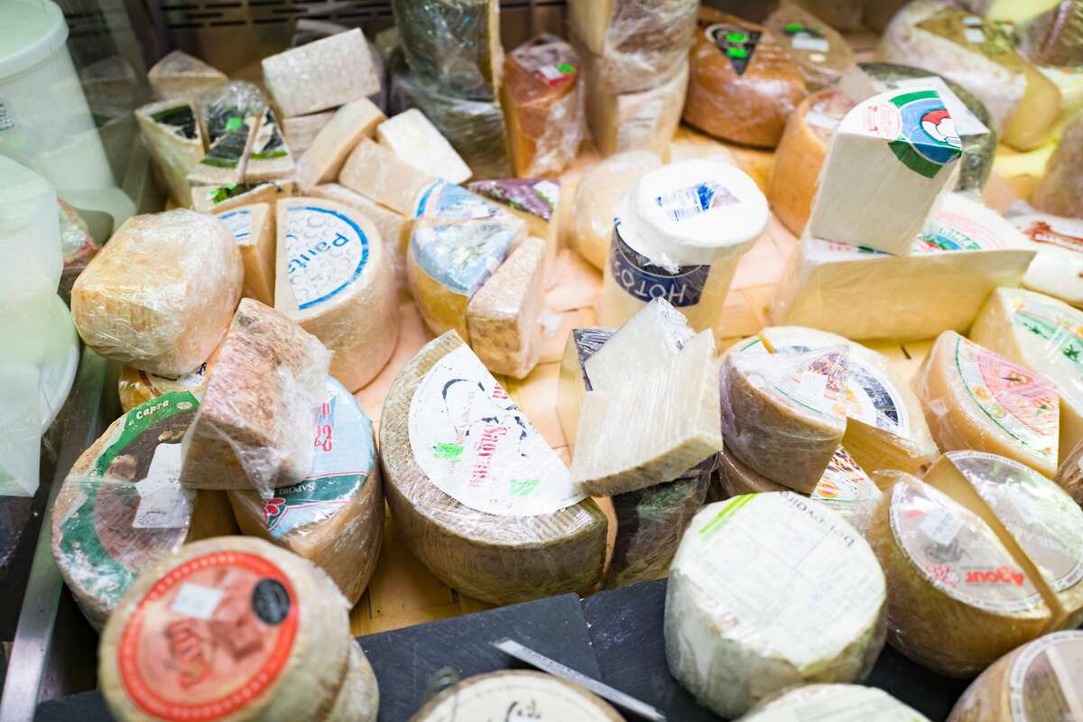 Close-up of artisan cheeses on display at Cheese Board Pizza, a worker-owned collective cheese shop in Berkeley. Elizabeth Valoma, the co-founder of The Cheese Board, has died at 91. 