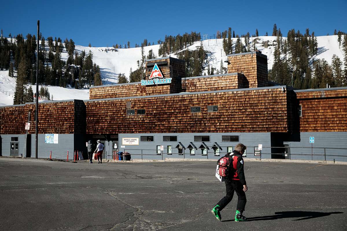 A person walks through the parking lot at Bear Valley Ski Resort in April.