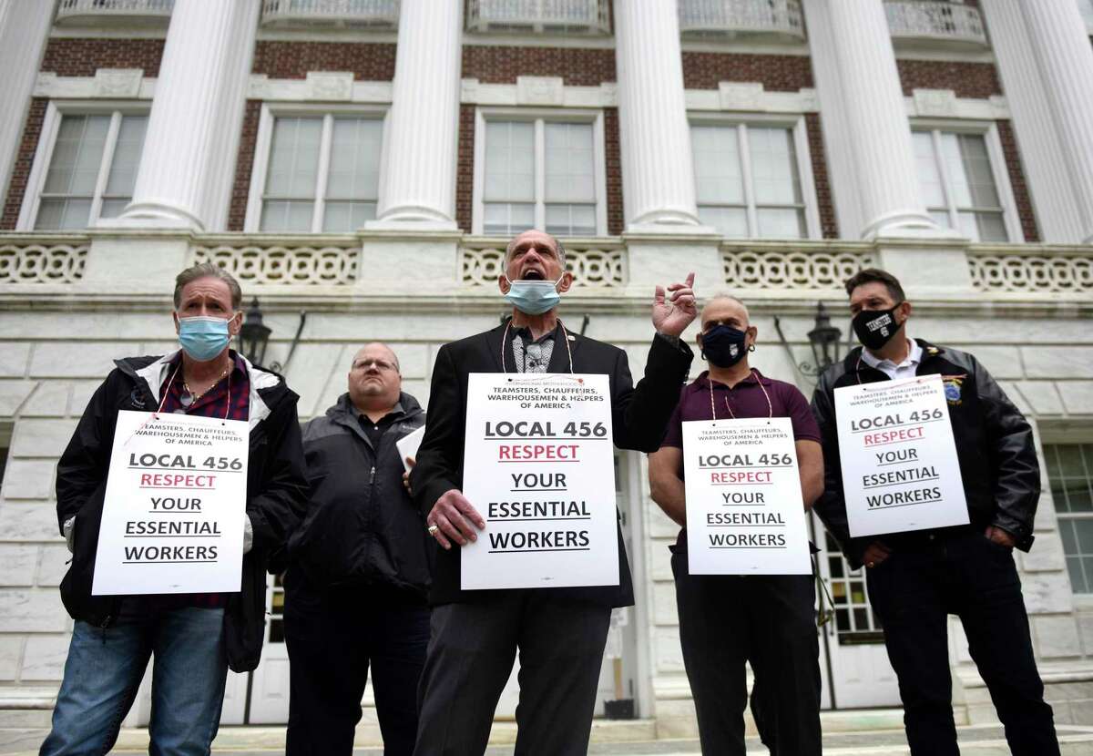 Teamsters Local 456 President and Principal Officer Louis Picani rallies with Greenwich town employees outside Town Hall in Greenwich on Monday. Town workers say they have been working without a contract for more than two years.
