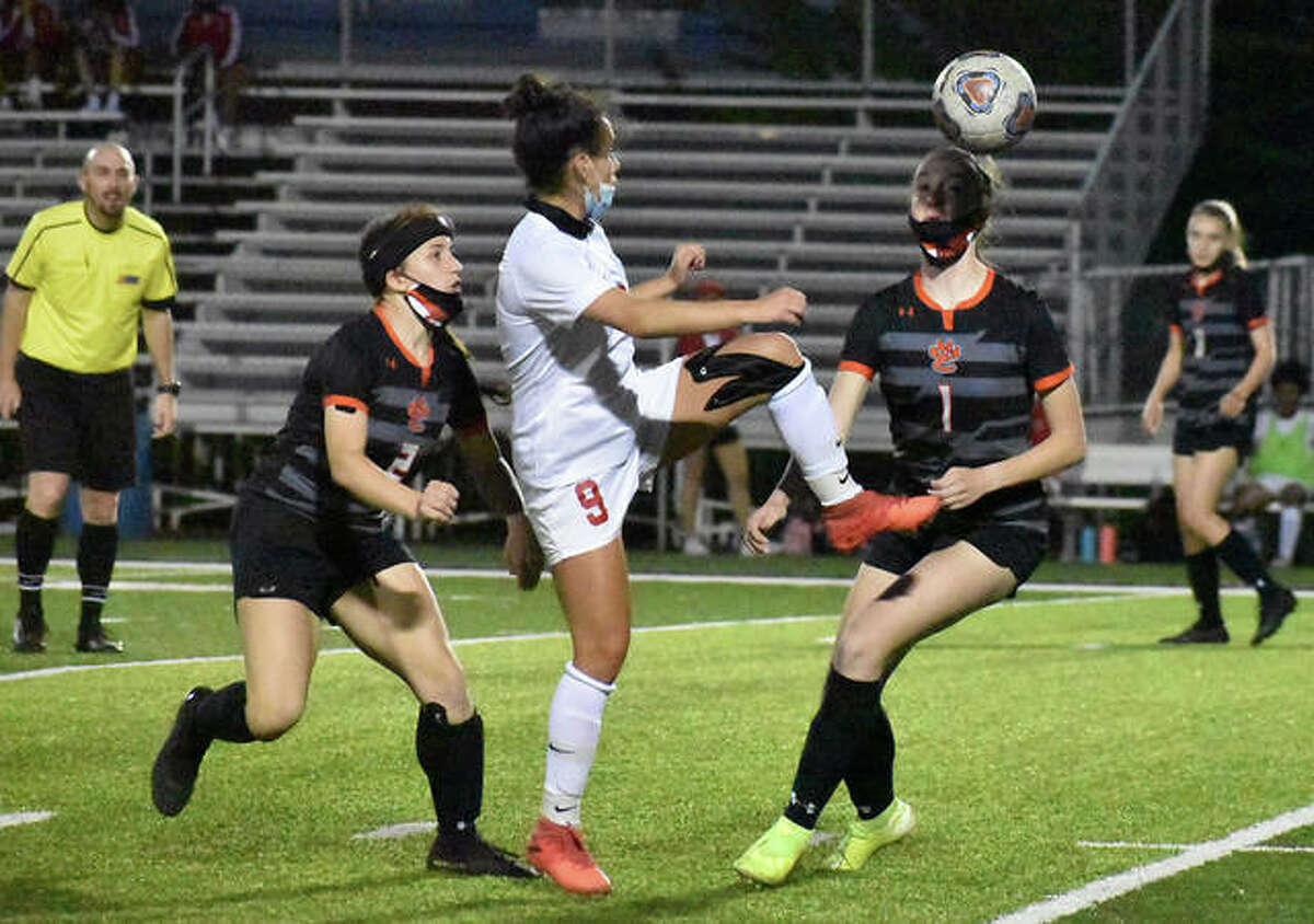 Alton’s Emily Baker, center, scored her first career goal Monday in the Redbirds’ 1-0 win over Civic Memorial in a Metro Cup Showcase game at Edwardsville. Baker is shown earlier this season in action against Edwardsville.