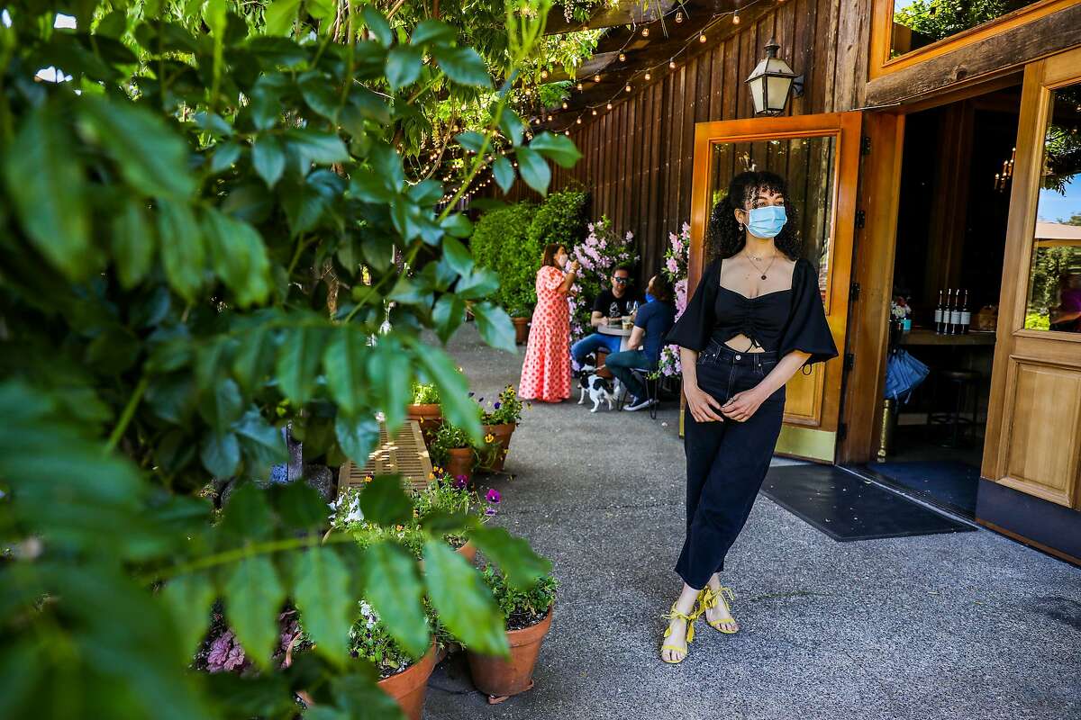 Instagram wine influencer Amber Lucas poses for a portrait as a friend takes photos of her at Lambert Bridge Winery in Healdsburg.