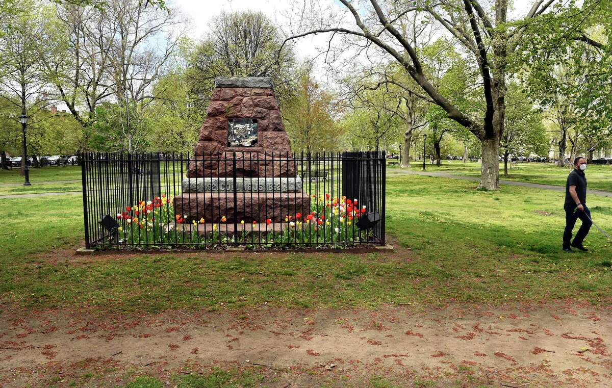 The base of the statue of Christopher Columbus remains in Wooster Square in New Haven on April 30, 2021, following the statue’s removal in June 2020.