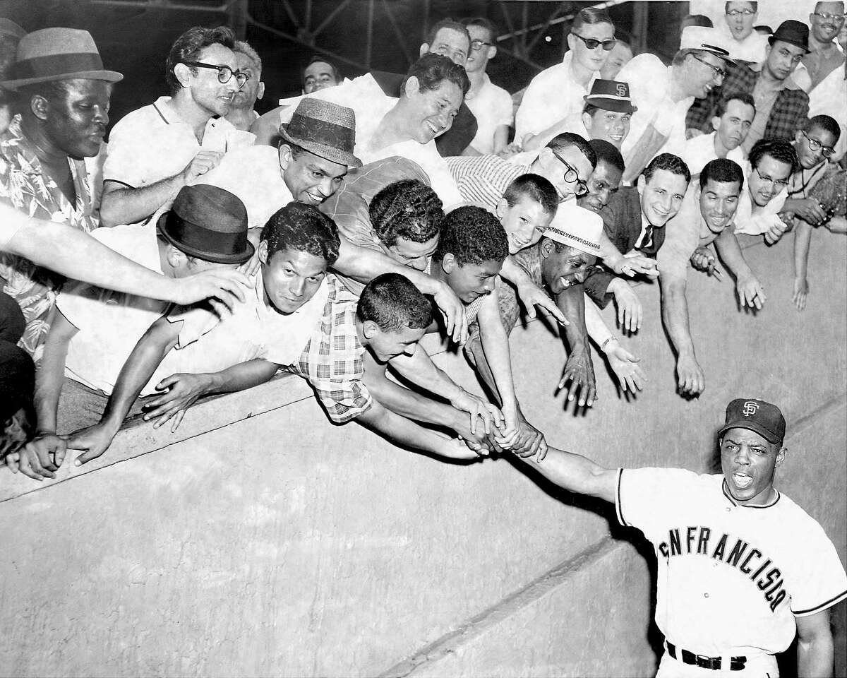 Fans at the Polo Grounds in New York greet the Giants' Willie Mays before a game in June 1962, during the Mets' inaugural season. Mays hit his 17th home run of year that night off future Giants manager Roger Craig.