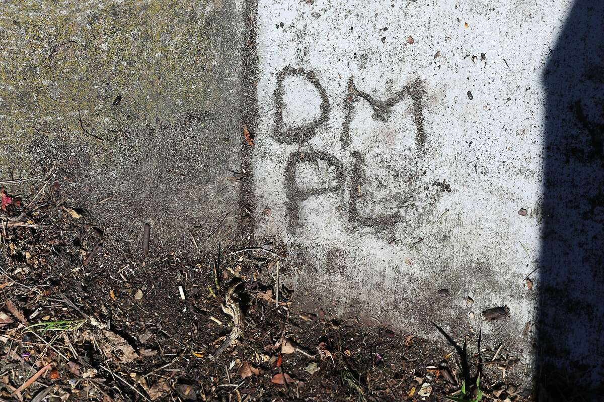 The initials of Phyllis Lyon and Del Martin are carved into the sidewalk in front of their house.
