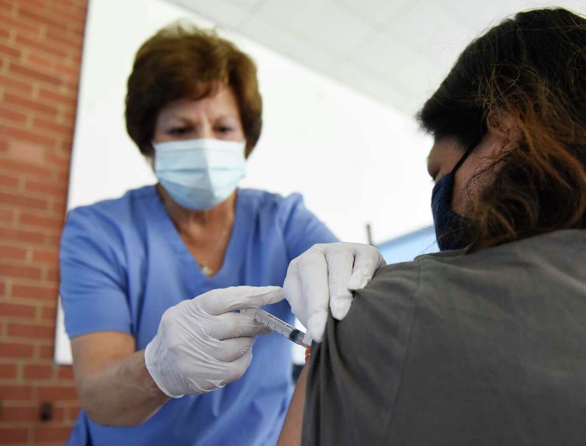 Riat Conte, RN, administers the Moderna COVID-19 vaccine to Riverside’s Jenny McCawley at the Family Centers Vaccination Clinic at the Eastern Greenwich Civic Center in Old Greenwich, Conn. Wednesday, April 28, 2021.