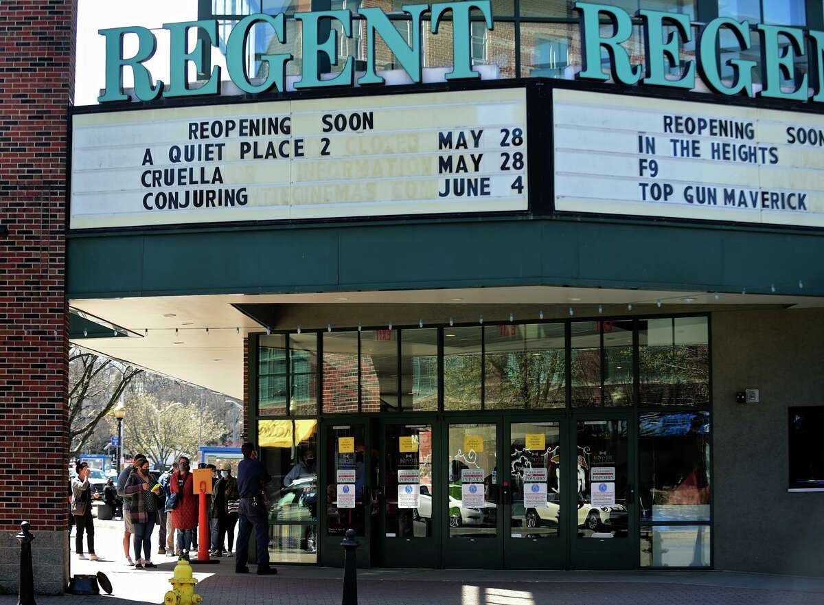 The Bow Tie Ultimate Regent 8 advertises upcoming releases on its marquee in South Norwalk, Conn., in April 2021 as people entered the theater for a COVID-19 vaccination clinic. Connecticut’s entertainment and leisure sector could see a 16 percent rebound in employment between 2020 and 2022, according to estimates by the state Department of Labor released in May 2021.