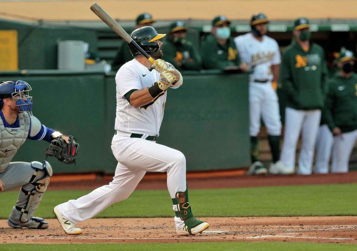 Mitch Moreland (18) watches his two-run homerun go over the fence in left in the secon dinning as the Oakland Athletics played the Toronto Blue Jays at the Coliseum in Oakland, on Tuesday, May 4, 2021.