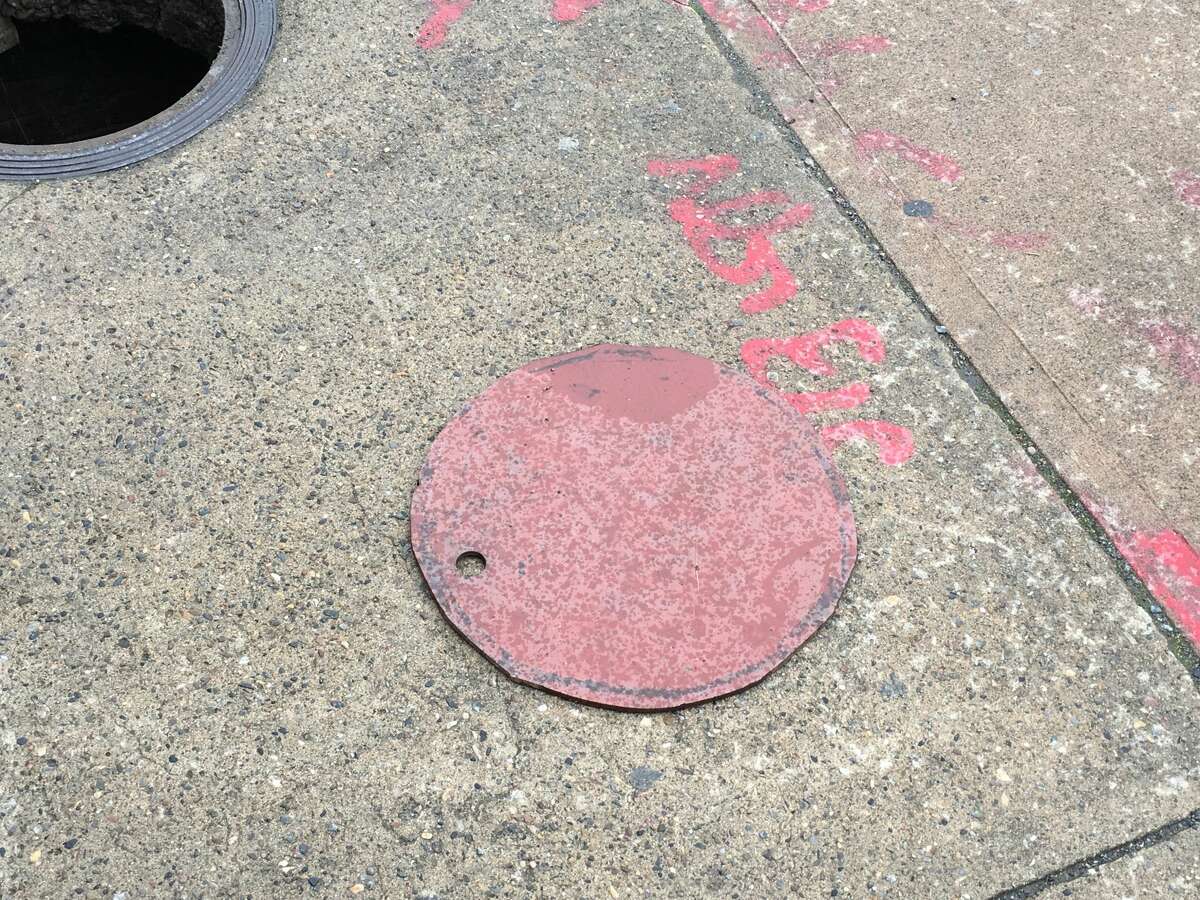 This is the manhole cover and underground area where a man came and went Sunday in Schenectady.
